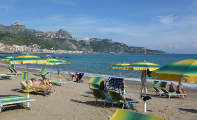 Beach umbrellas and sunbathers, Giardini Naxos