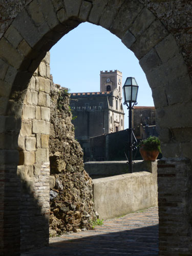 View of Savoca through a ruined archway