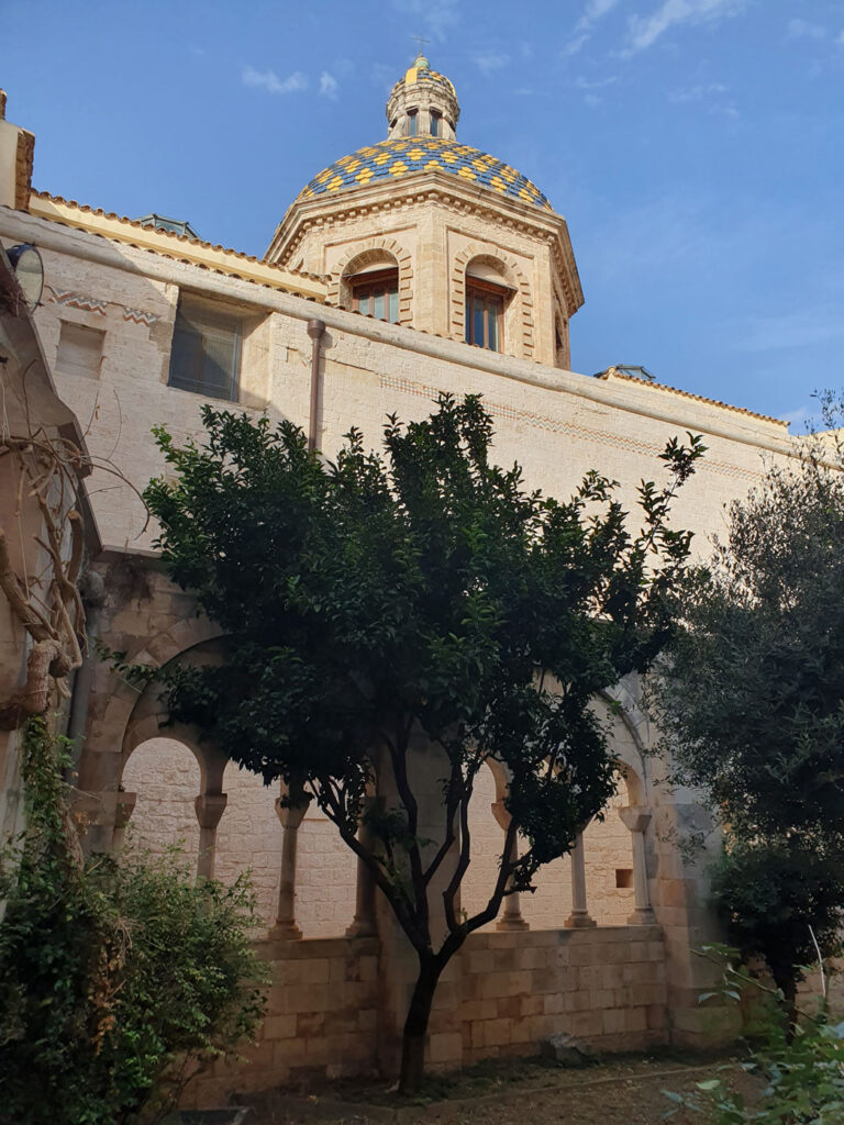 View of the cloister at the Monastero di San Benedetto, Conversano, featured in Jumping from High Places