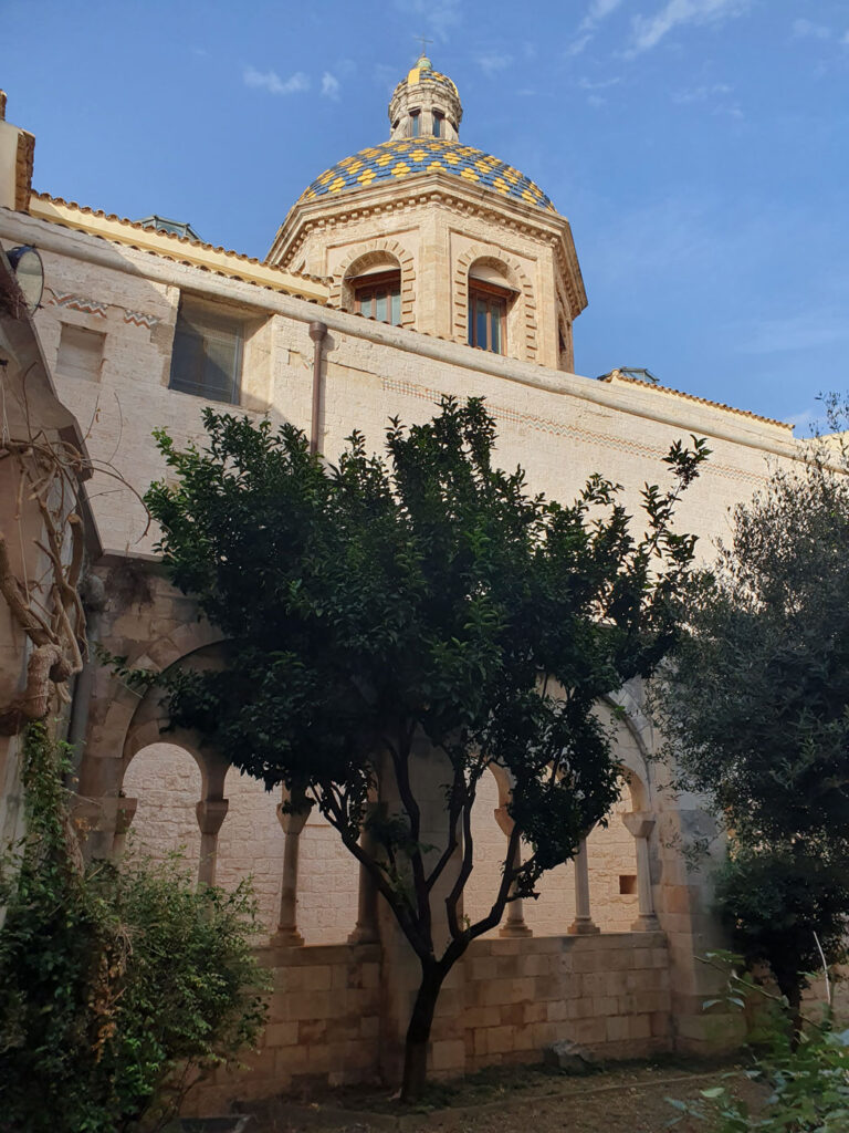 Eleventh-century cloister of the Monastero di San Benedetto In Conversano, and the church's tiled cupola