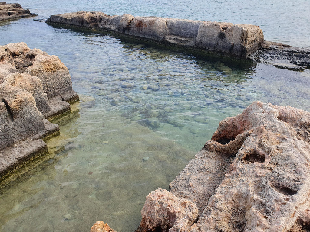 Rock-cut pools and a stone 'seat' near the Abbazia di San Vito
