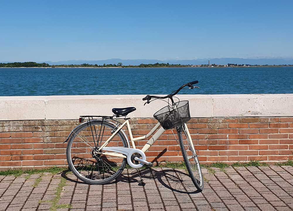 Bicycle by a wall with lagoon views